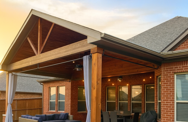 Covered backyard patio with a wood pergola, outdoor seating
