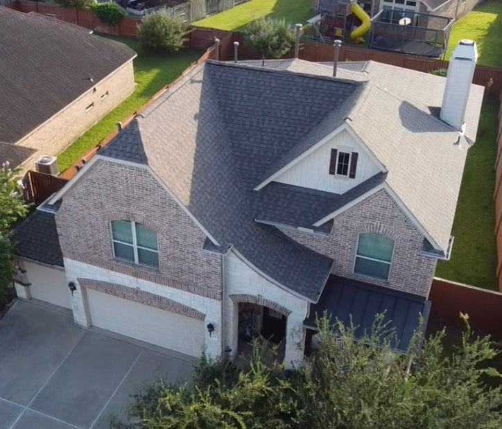 Aerial view of a Houston home with a roof replaced by Prime Property Builders.