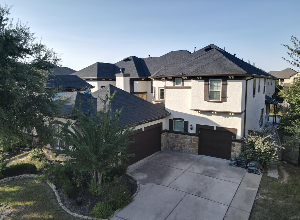 High-end residential home in Houston featuring a newly installed premium asphalt shingle roof by Prime Property Builders.