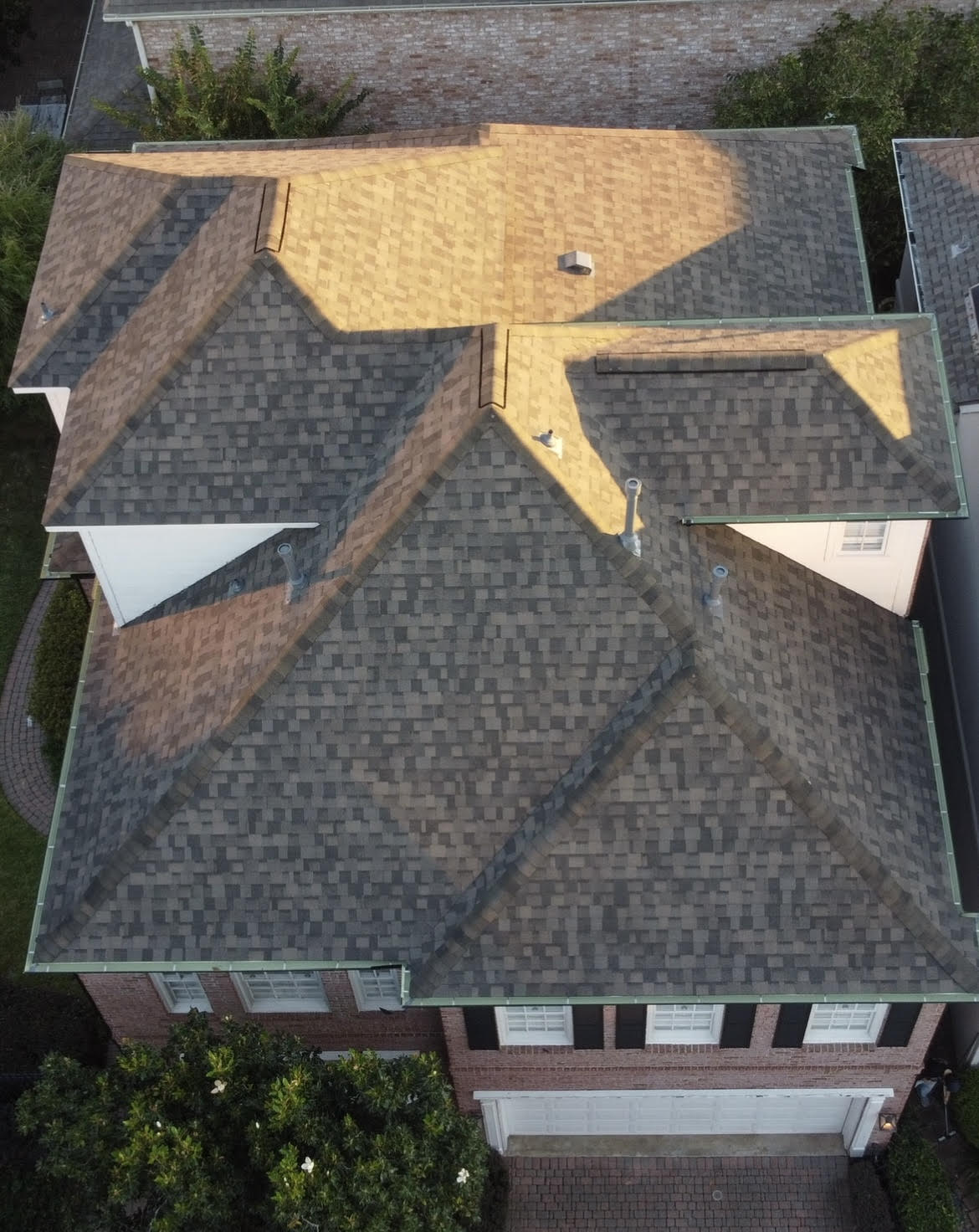 Aerial view of a residential home in Houston, Texas showing an asphalt shingle roof photographed by Prime Property Builders during a roofing project.