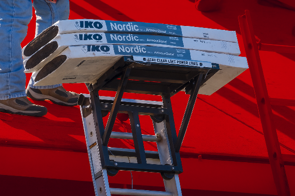 Class 4 shingles staged on a ladder system for professional roof installation.