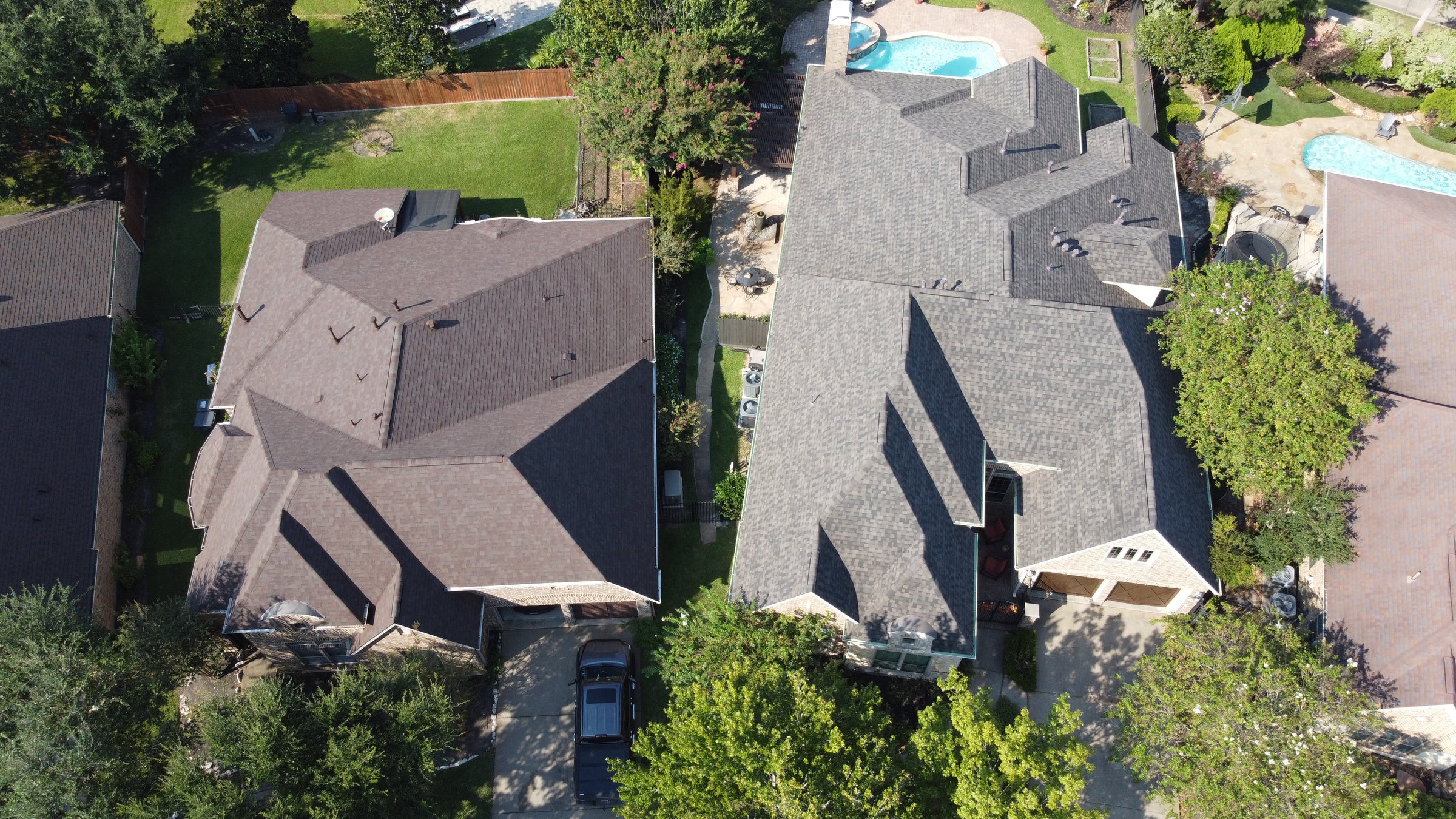 Drone aerial of residential roof replacement in Texas by Prime Property Builders.