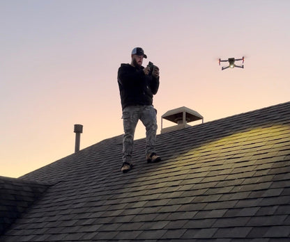 Roofing inspector using a drone to perform a professional roof inspection and document roof conditions from above.