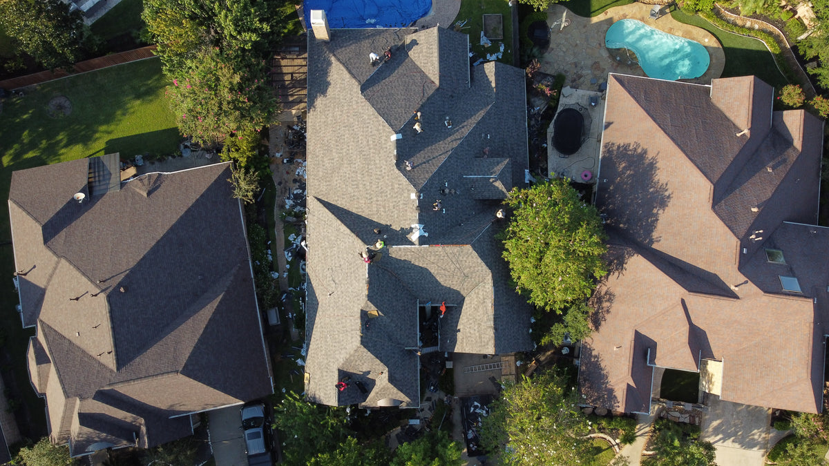 Aerial view of a roof installation in progress at a Houston home by Prime Property Builders’ professional roofing crew.