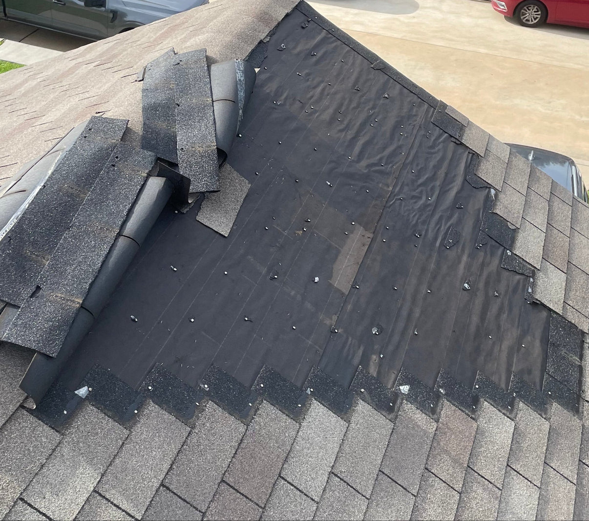 Damaged roof with missing shingles in Houston.