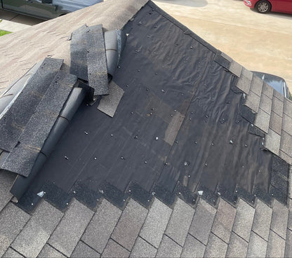 Damaged roof with missing shingles in Houston.